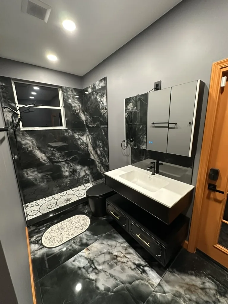 Finished bathroom with walk-in shower, floating vanity, storage, and mirror cabinets