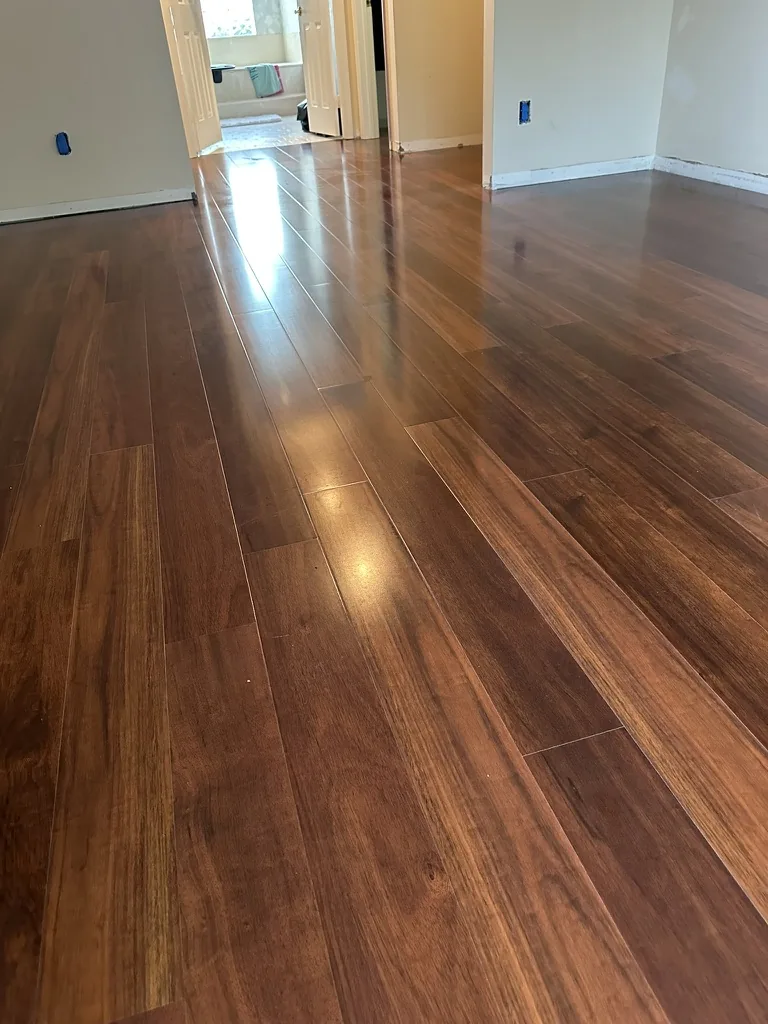 Warm wood-look plank flooring during bedroom installation
