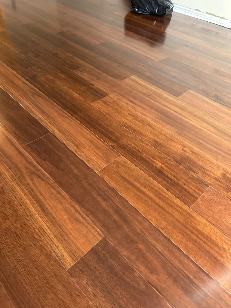 Close view of the engineered wood plank pattern during bedroom installation