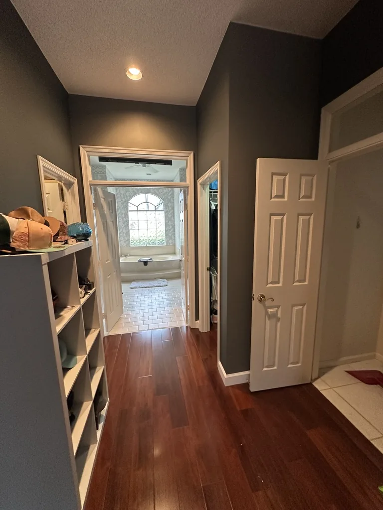 Engineered wood floor continuing into the adjoining painted dressing area