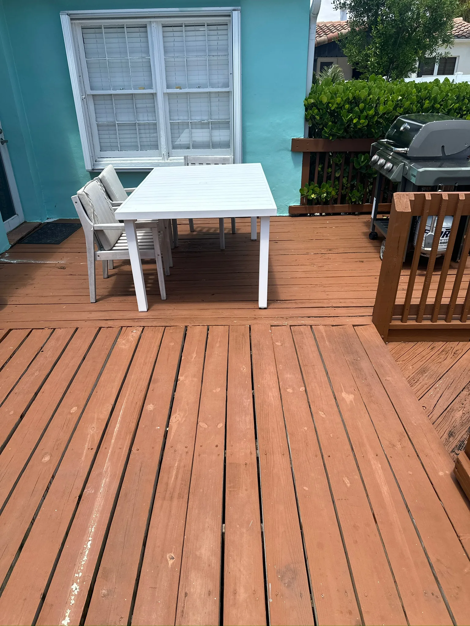 Weathered backyard deck before preparation and repainting