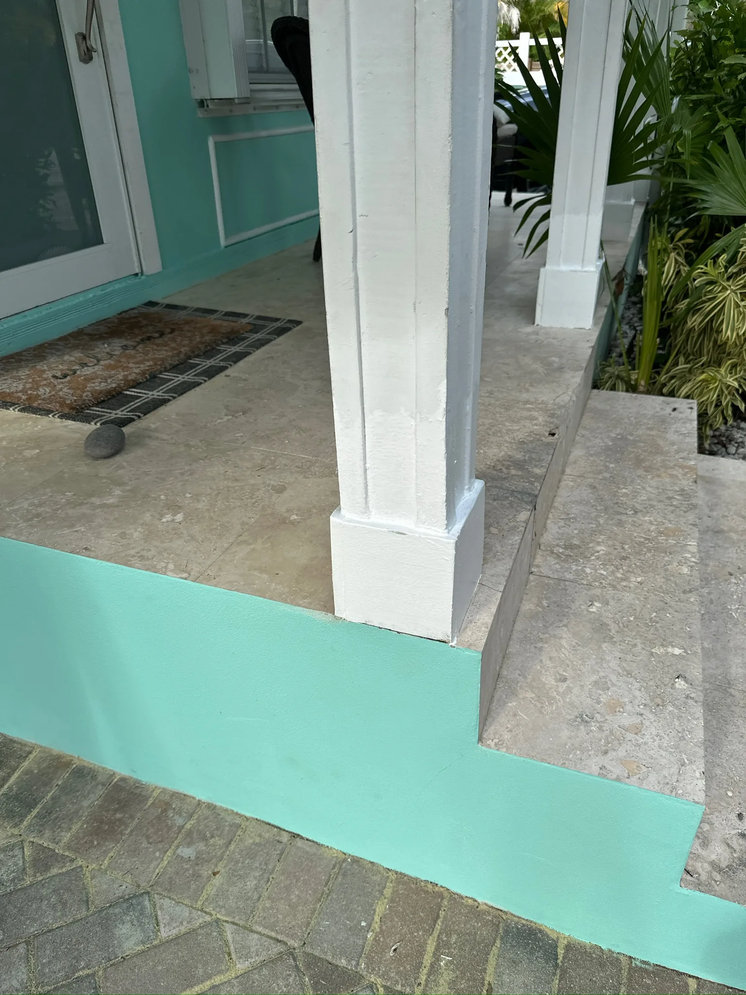 Repaired and white-painted porch column base