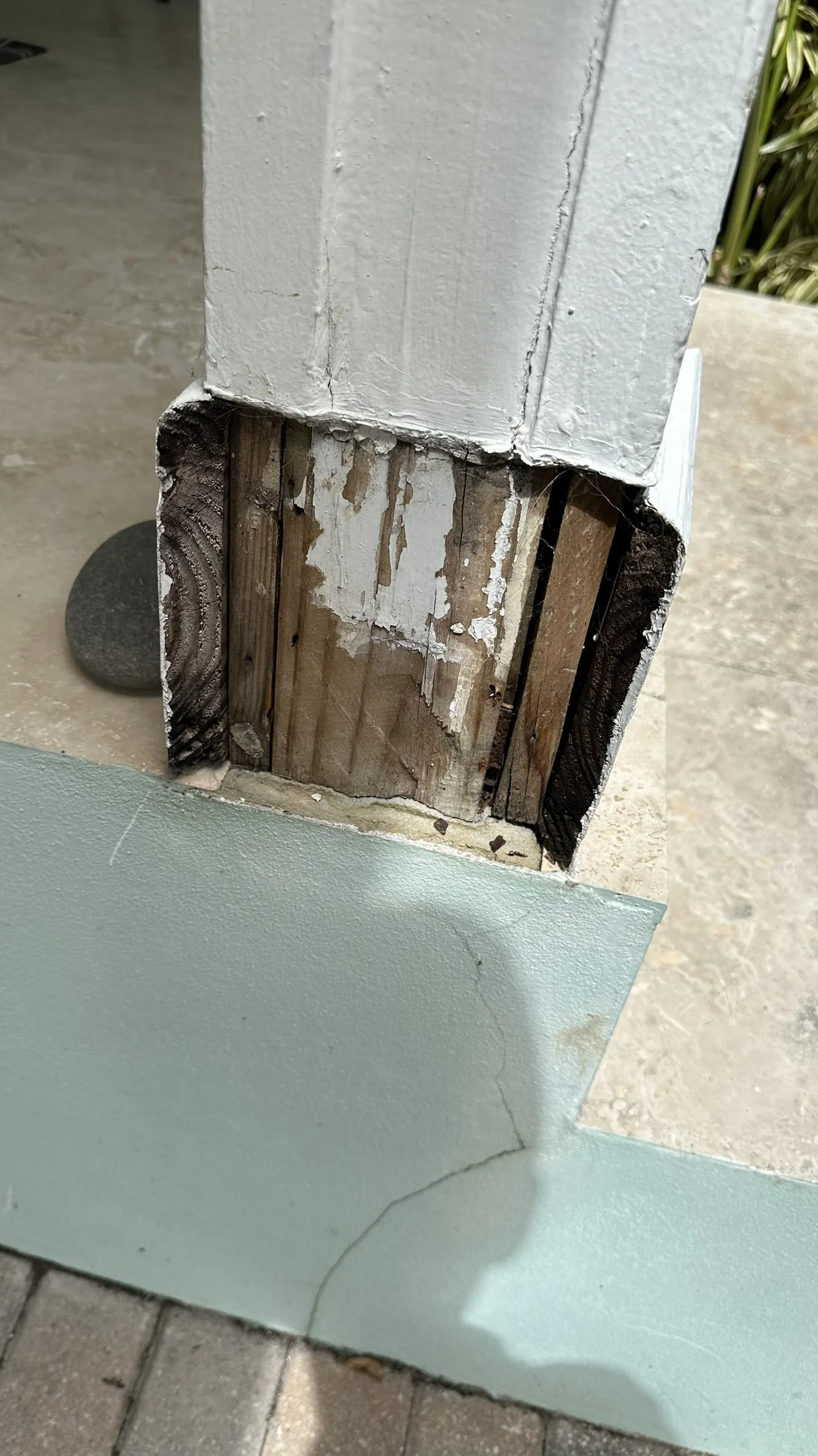 Deteriorated lower porch column-base trim before repair