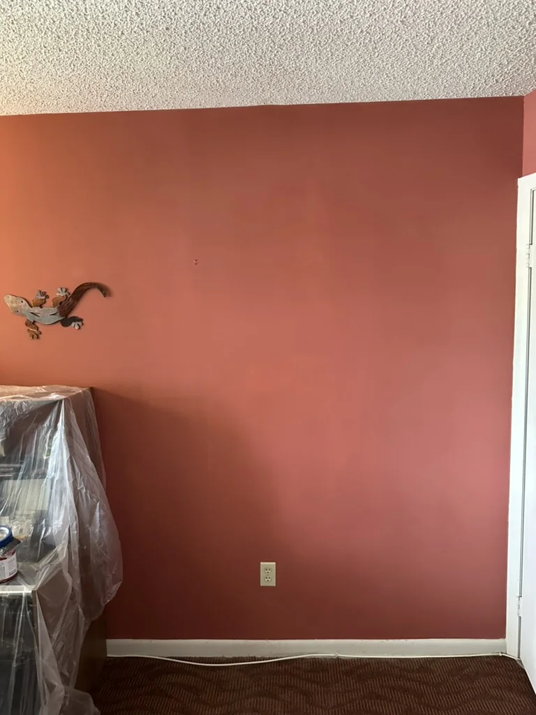 Finished red wall after localized drywall repair and painting