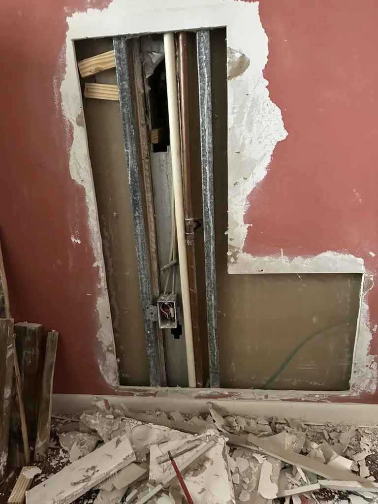 Existing L-shaped wall opening before drywall surface repair
