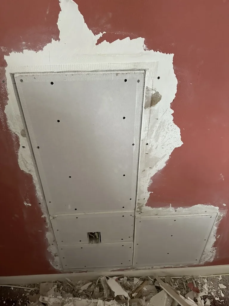 Mesh reinforcement applied across drywall patch seams
