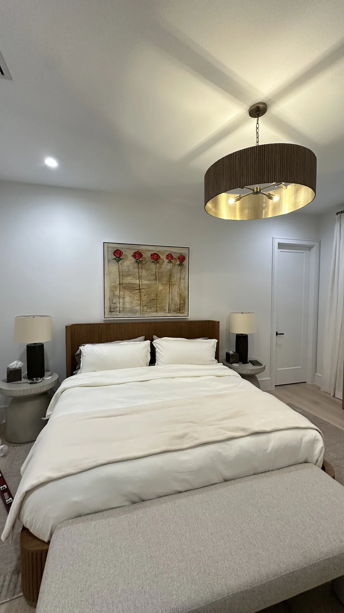 Finished bedroom with mounted artwork, installed furniture, and a pendant light