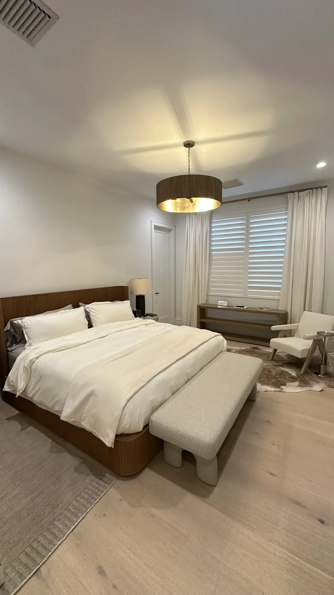 Finished bedroom with full-height curtains, furniture, and painted walls