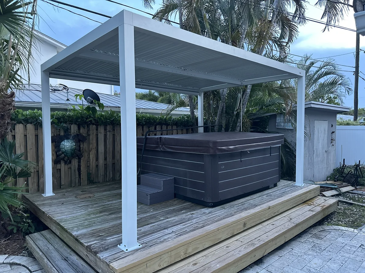 Freestanding louvered pergola installed around an outdoor hot tub