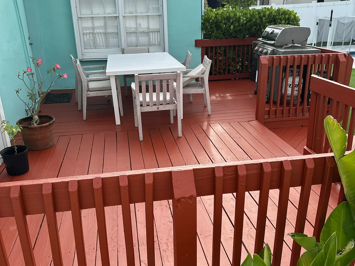 Backyard deck refinished in warm red-orange paint