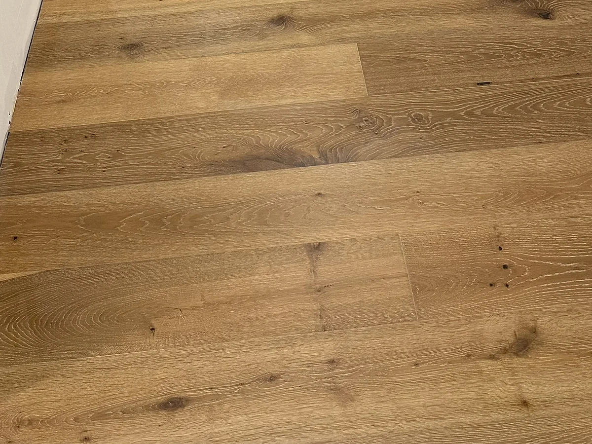 Warm natural wide-plank flooring with varied wood grain